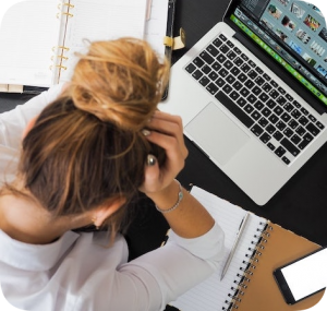 exasperated woman working at computer